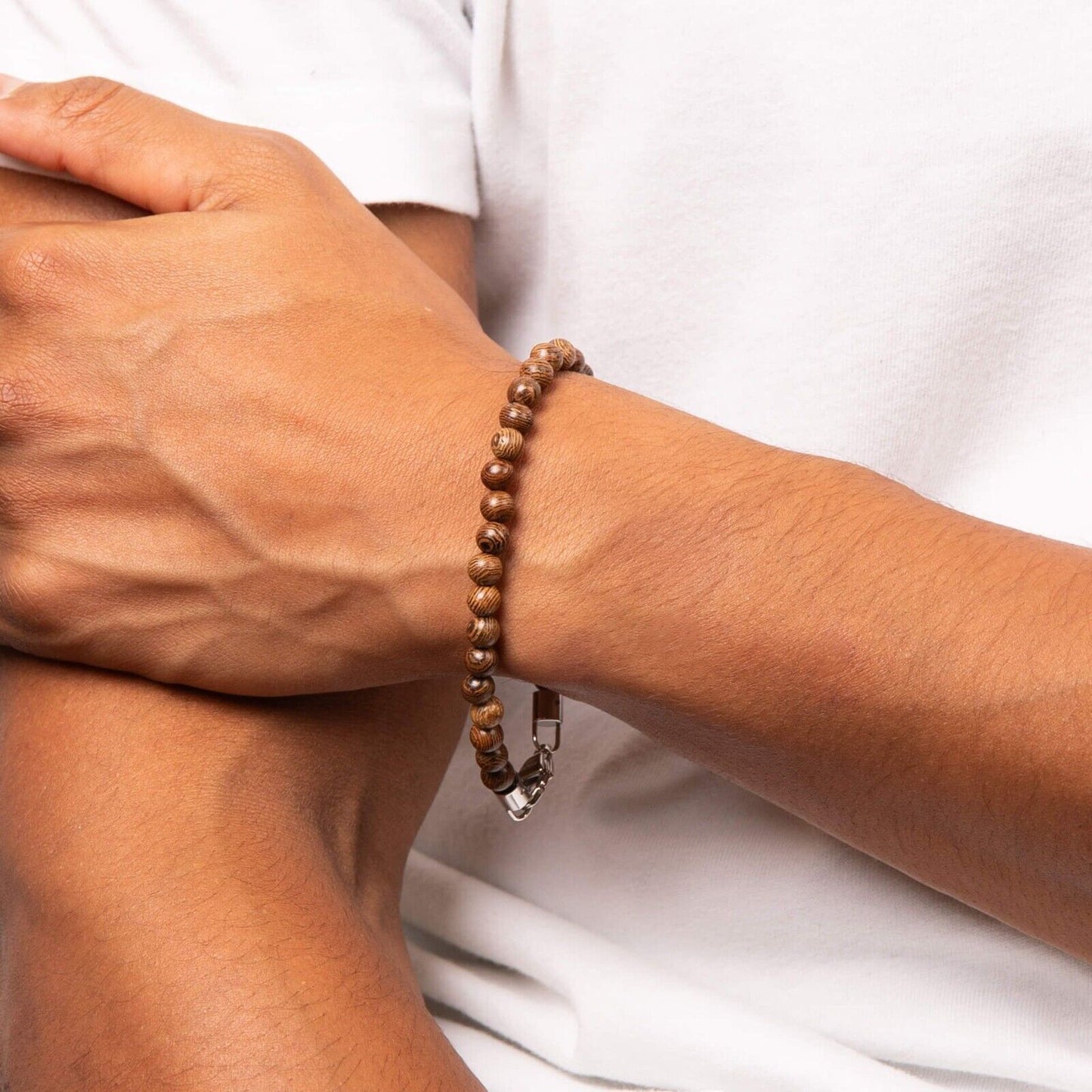 Fred Bennett men's brown wooden bead bracelet worn on wrist with white shirt background