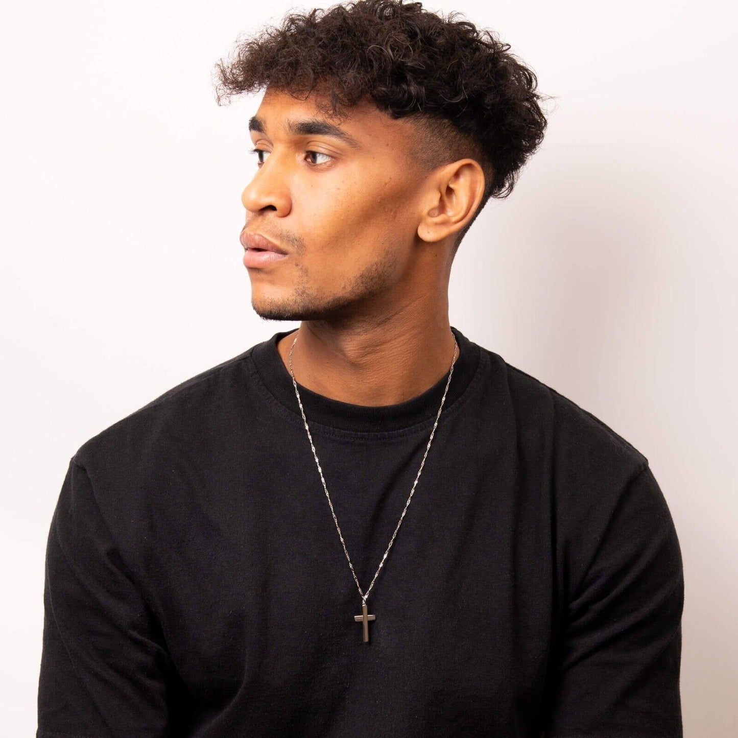Man wearing a silver Celtic Tree of Life pendant necklace with a black shirt from Fred Bennett