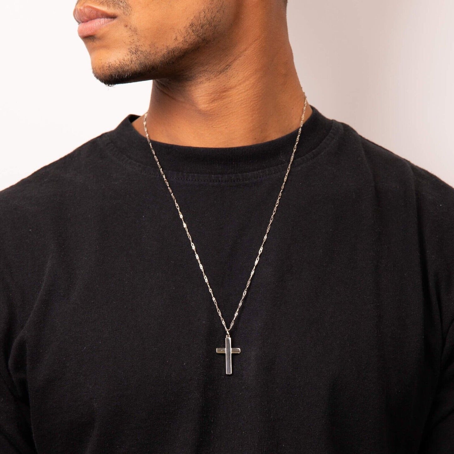 Man wearing silver Celtic Tree of Life pendant on chain over black shirt by Fred Bennett