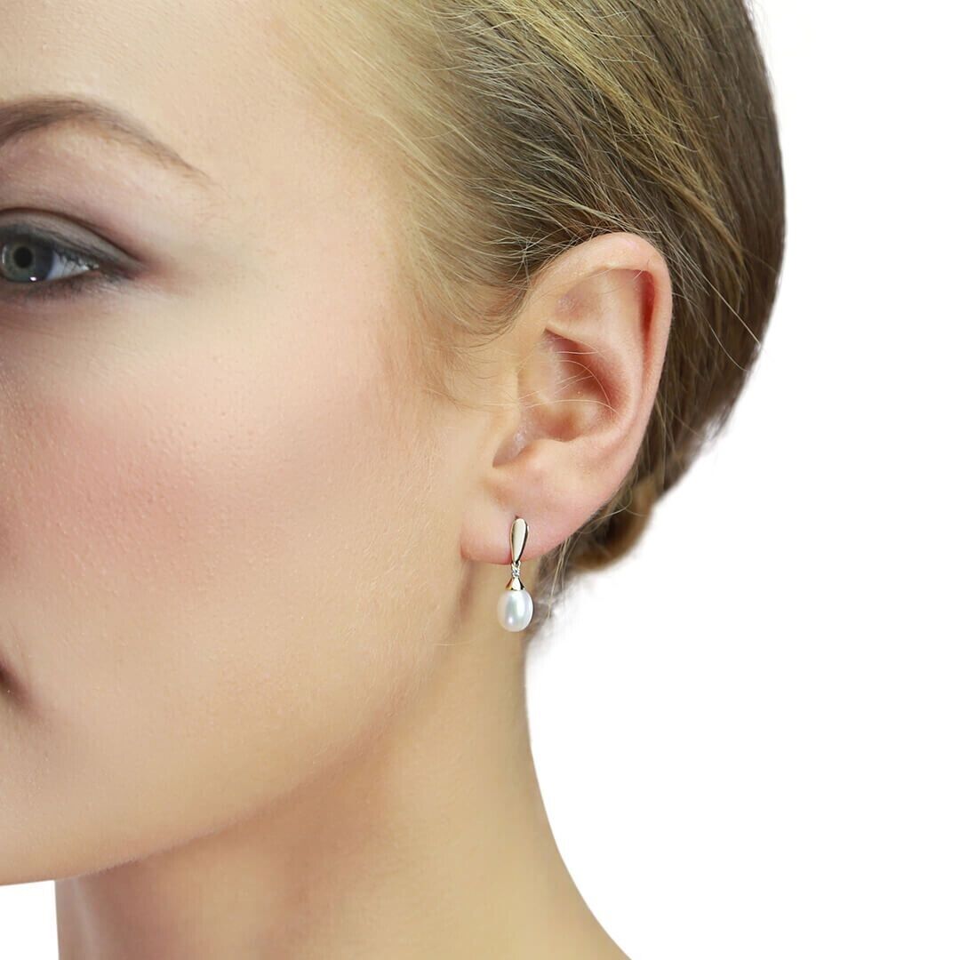 Freshwater pearl and diamond pendant set worn on ear showcasing elegant drop design by J R Jewellery