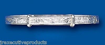 Solid silver childrens bangle with intricate engraved design by J R Jewellery on blue background