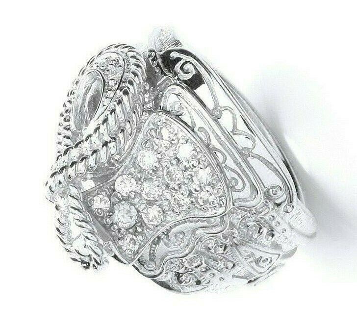 Intricately designed sterling silver gents saddle ring with detailed patterns and embedded stones