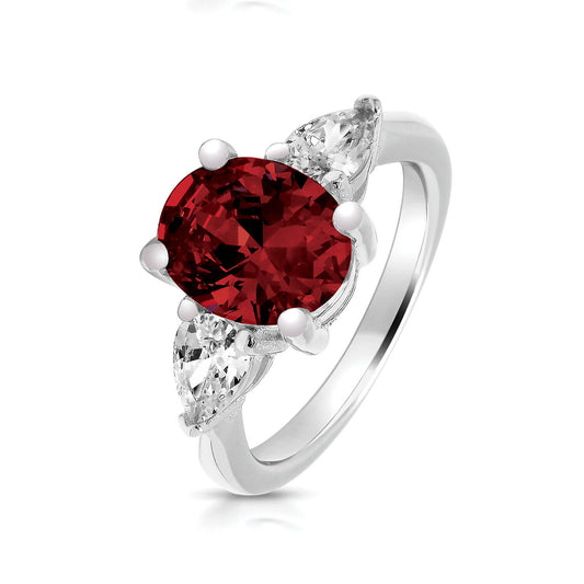 Sterling silver ruby trilogy ring with a large oval ruby and two pear-shaped clear stones