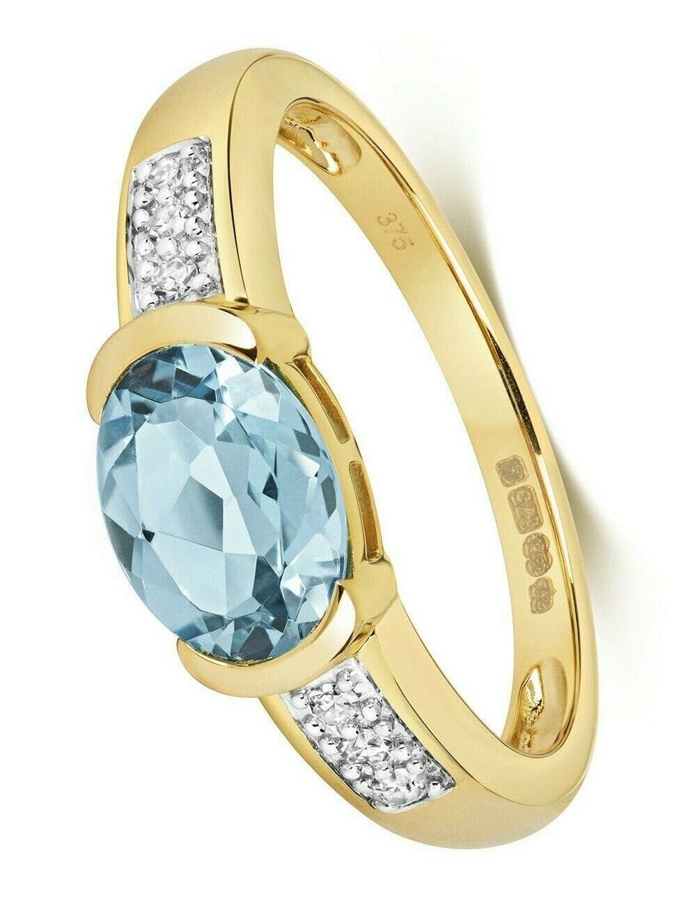 J R Jewellery Swiss blue topaz diamond ring with oval gemstone set in gold band
