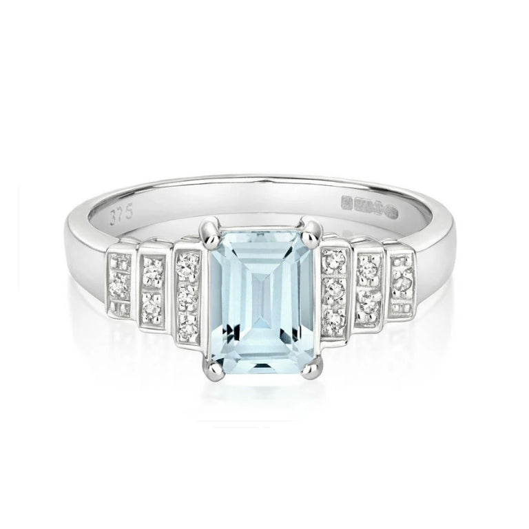 J R Jewellery aquamarine and diamond engagement ring with emerald cut centre stone and sparkling side diamonds