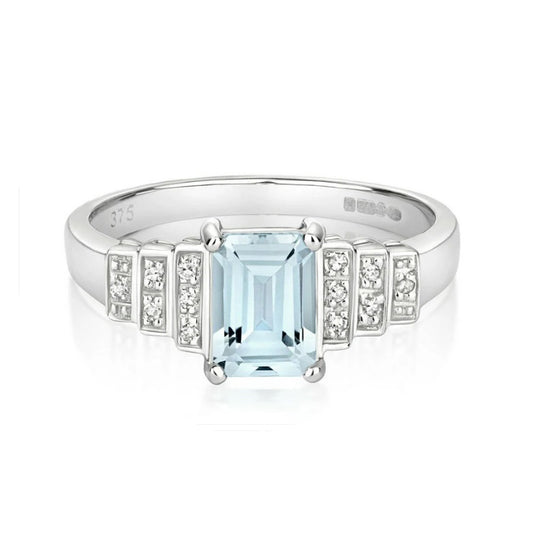 J R Jewellery aquamarine and diamond engagement ring with emerald cut centre stone and sparkling side diamonds
