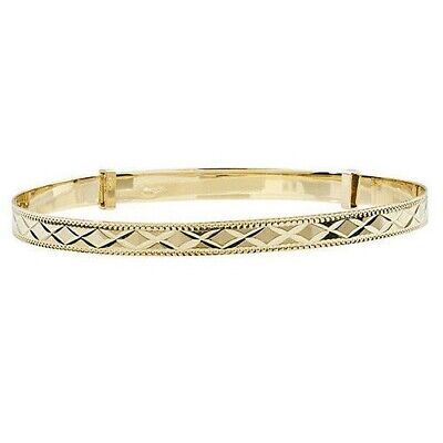 Yellow gold ladies bangle with intricate engraved diamond pattern and polished finish