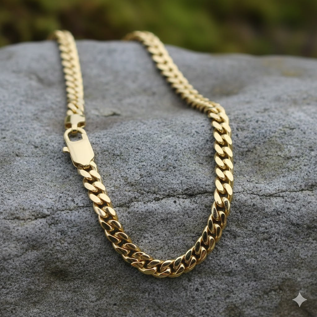18ct Gold Cuban Chain on a stone surface showcasing its shine and craftsmanship