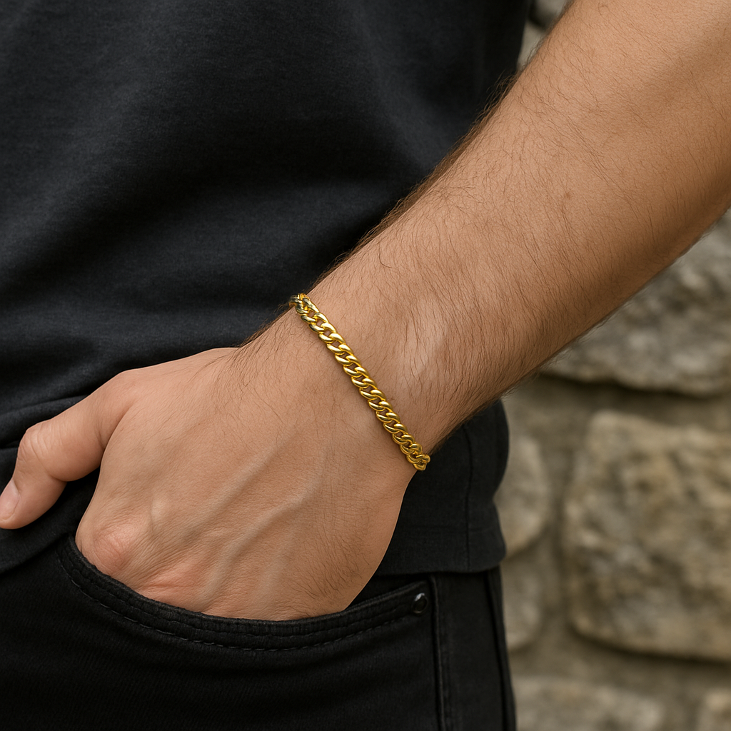 18ct Gold Mens Flat Curb Bracelet elegantly worn on a man's wrist against a stone background