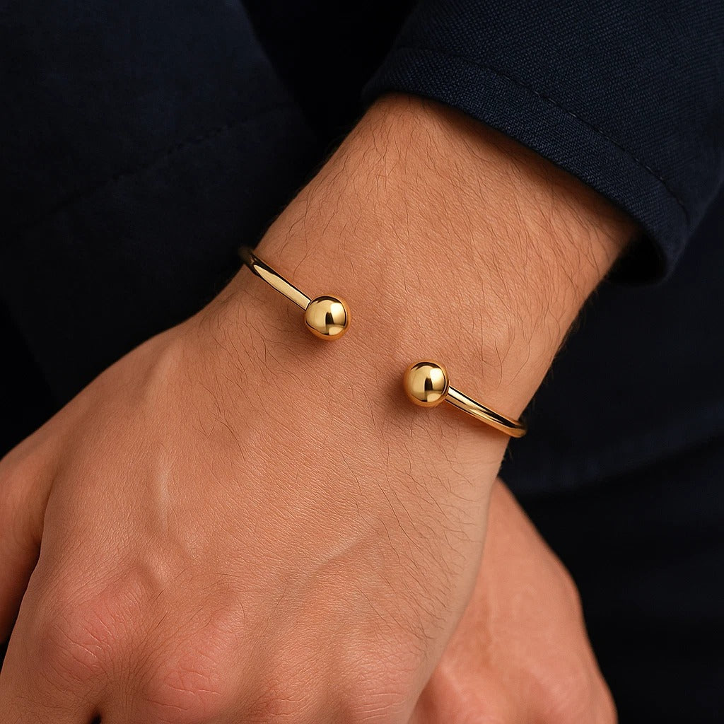 J R Jewellery 18ct Gold Mens Torque Bangle with Elegant Design and Ball Accents on a Stylish Hand