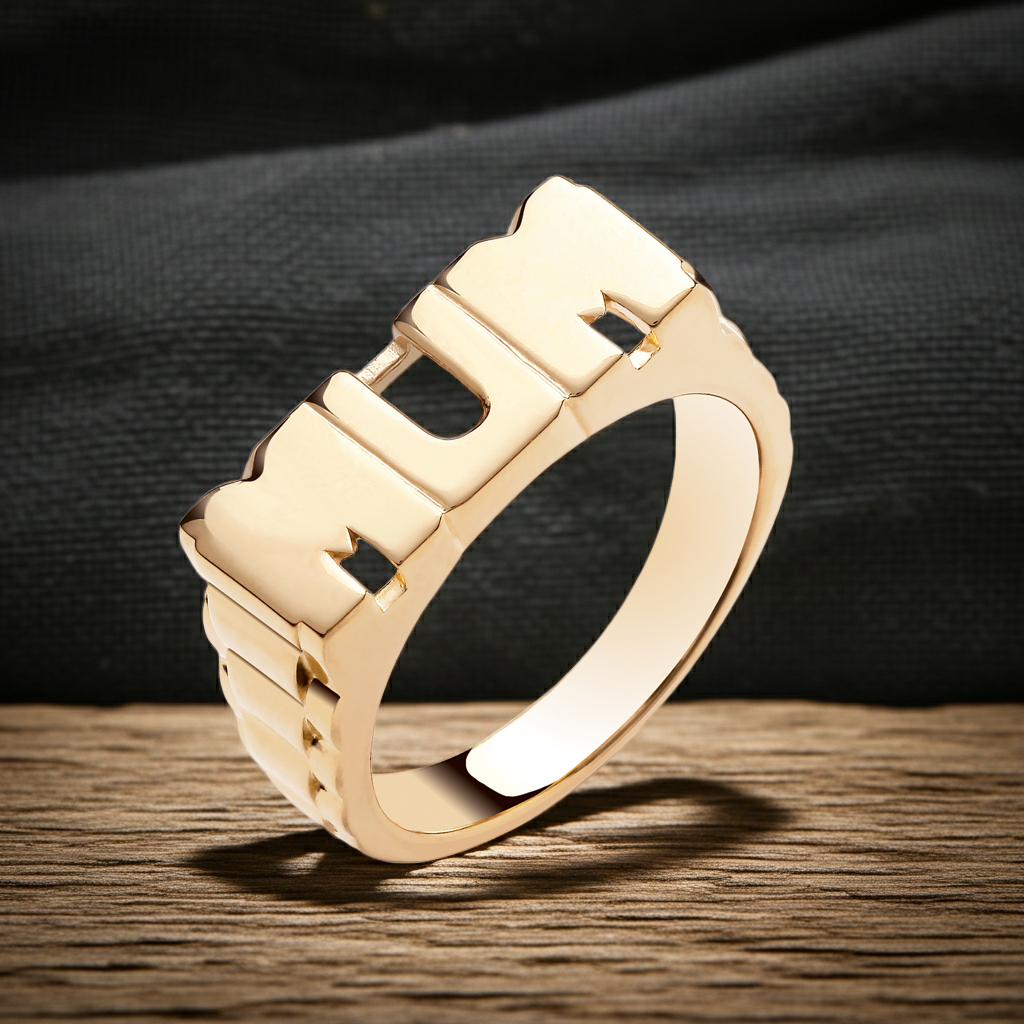 Stylish 18ct gold MUM ring with bold lettering on a wooden surface