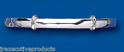 Child's solid silver bangle by J R Jewellery with a sleek polished finish on blue background