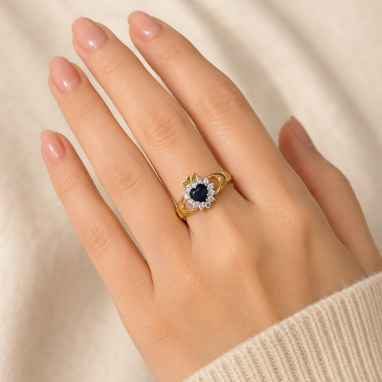 J R Jewellery Claddagh Ring featuring a sapphire centre stone and sparkling diamonds on a gold band