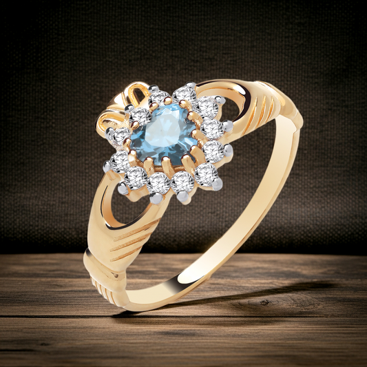 Stunning gold Claddagh Ring featuring an oval blue gemstone surrounded by sparkling diamonds