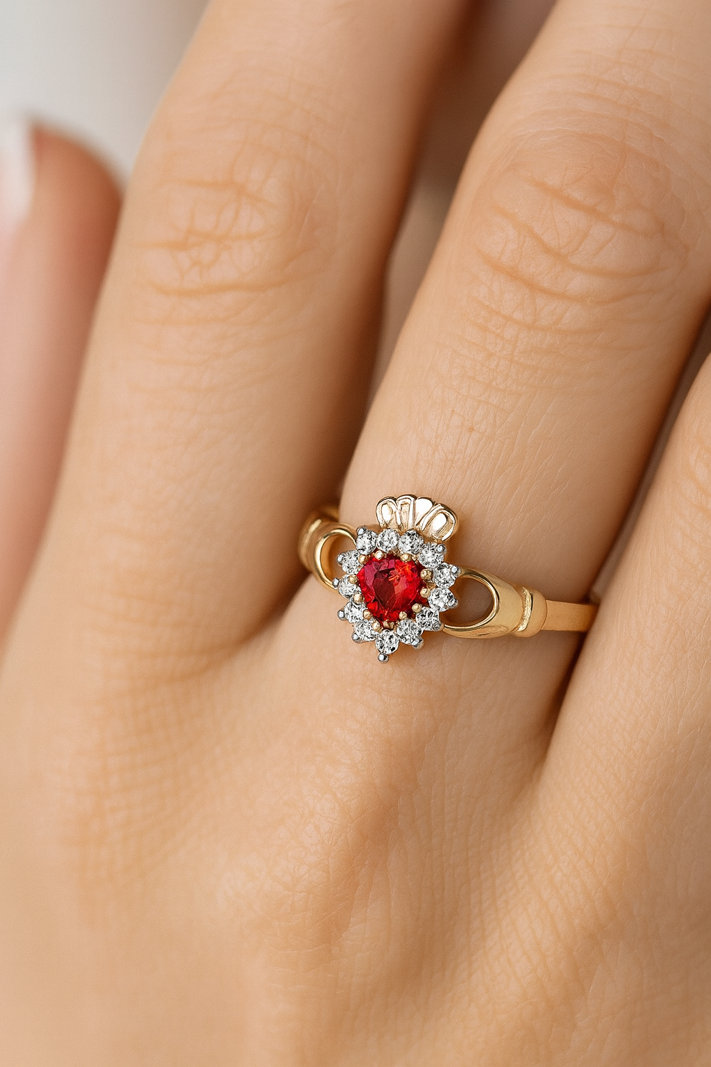 Elegant J R Jewellery Claddagh Ring featuring a ruby centre stone and diamond accents on a gold band