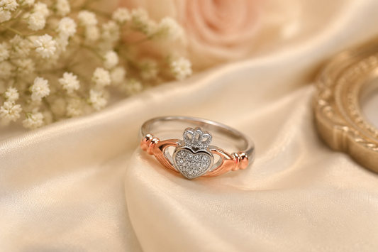 Elegant Claddagh Ring with Heart and Crown Design, Set on a Soft Satin Background