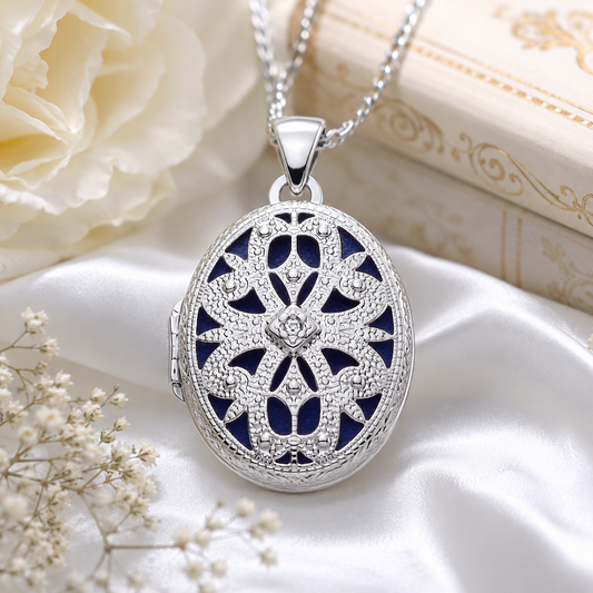 Elegant Oval Filigree Locket in silver with intricate design and chain, placed on satin fabric