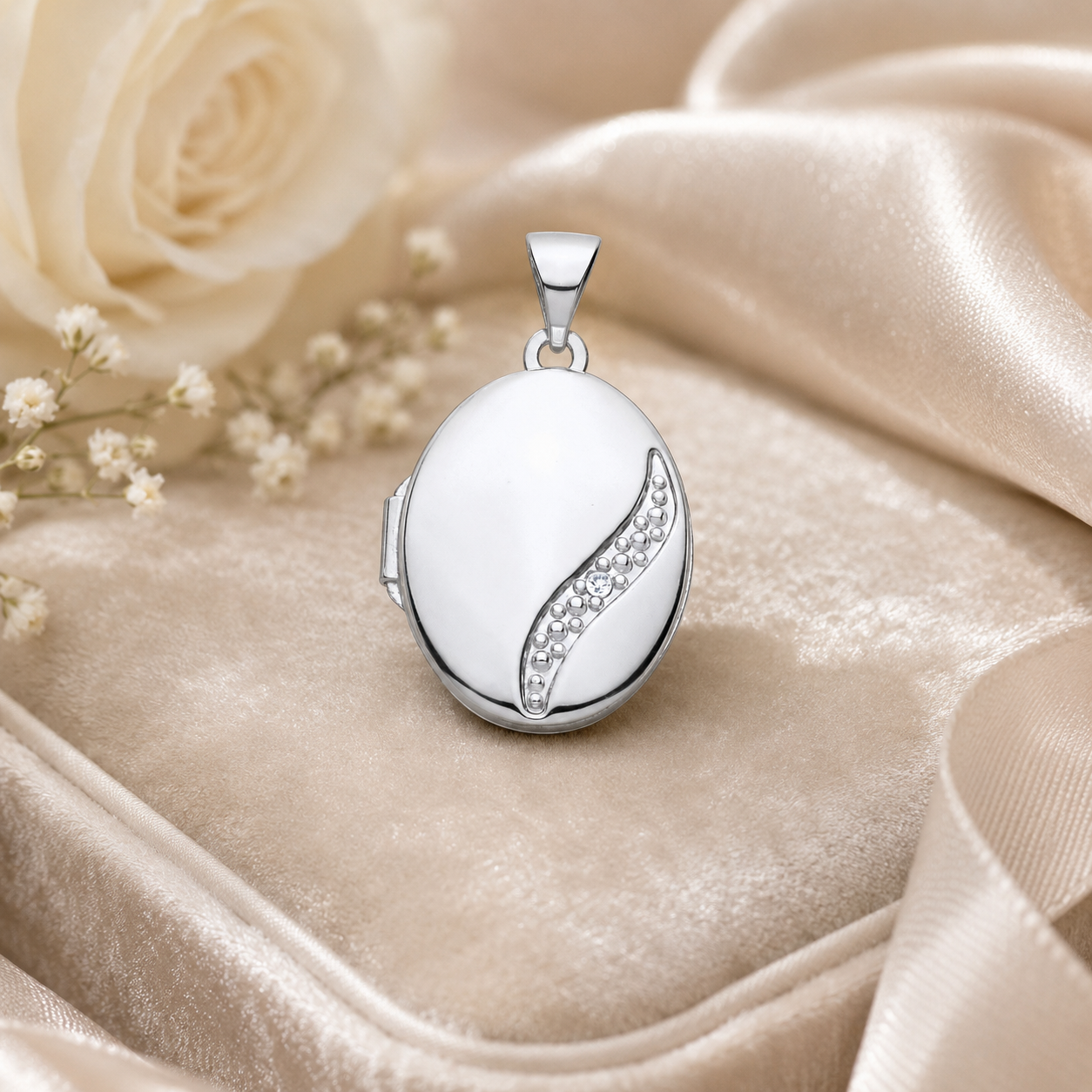 Elegant Oval Locket in Silver with a Decorative Design and Sparkling Accents on Soft Satin Background