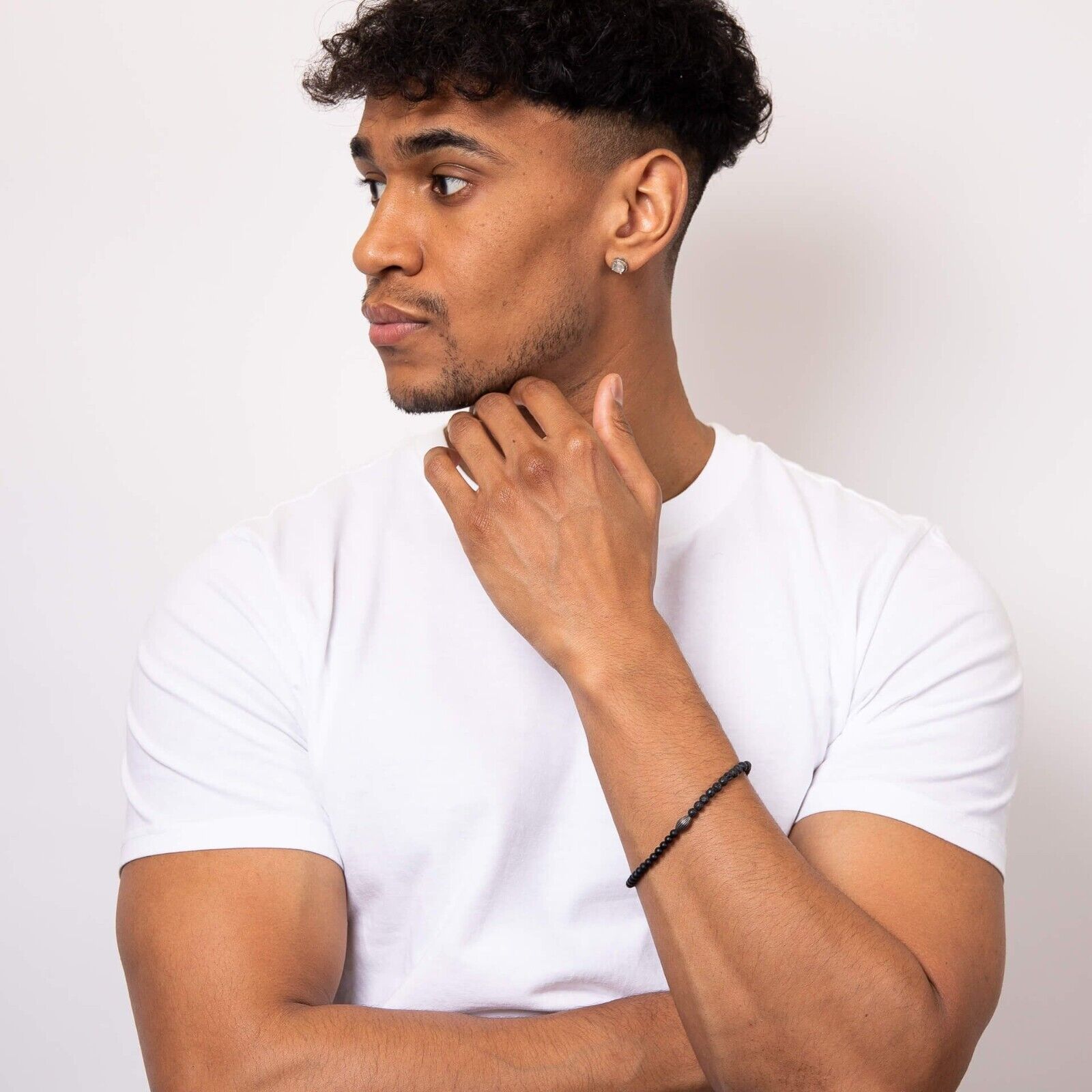 Fred Bennett men's beaded bracelet worn by man in white t-shirt showcasing stylish black beads