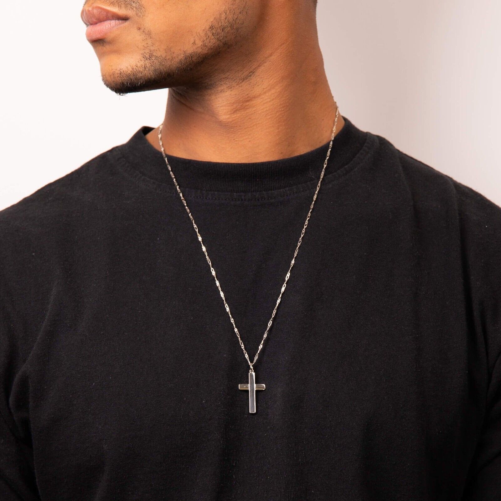 Man wearing silver Celtic Tree of Life pendant on chain over black shirt by Fred Bennett