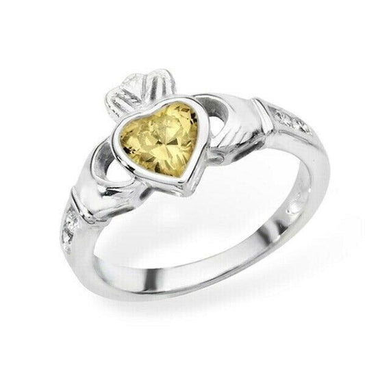 Silver Irish Claddagh Ring with a Yellow Heart-Shaped Gem and Detailed Design