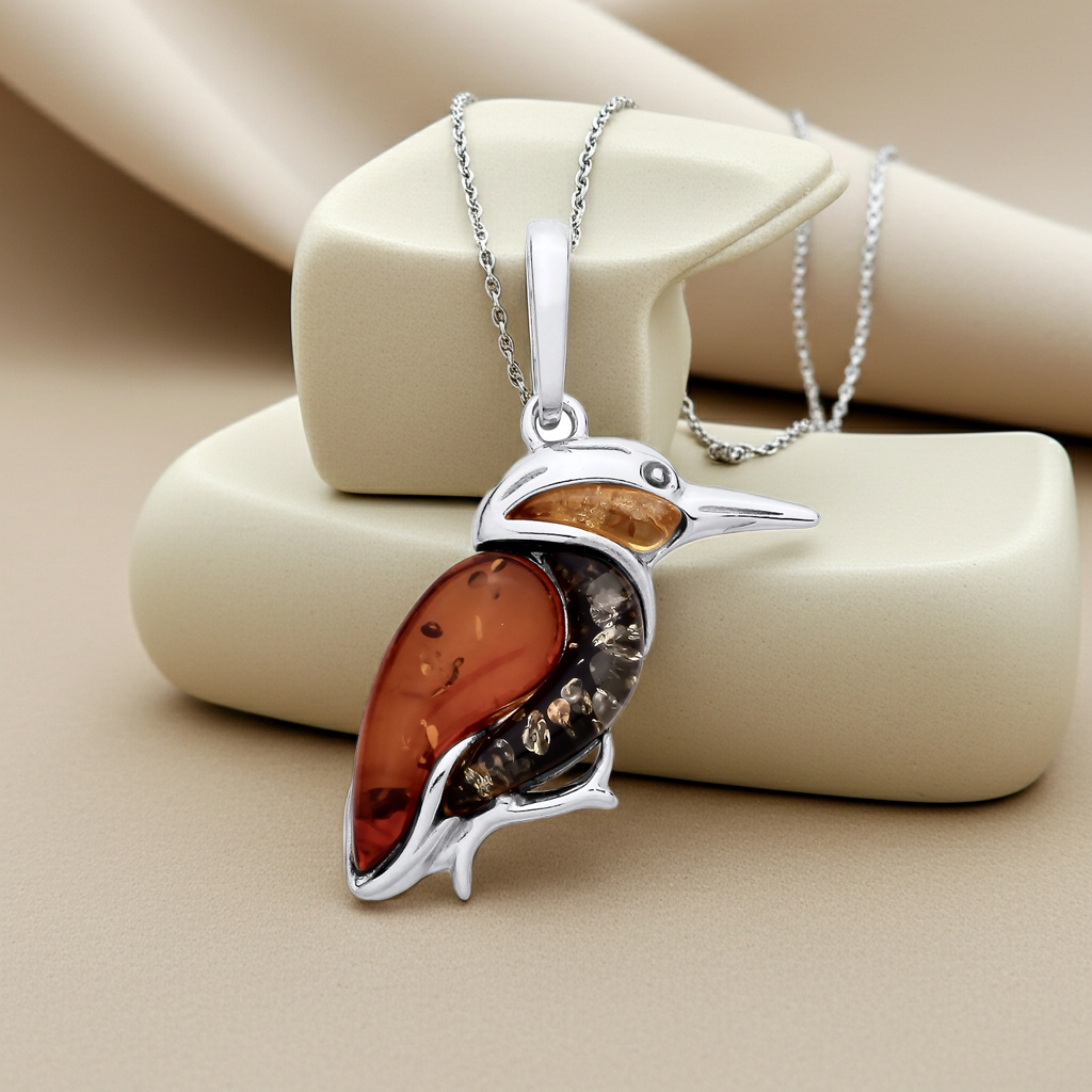 Elegant silver necklace featuring a Kingfisher Bird Pendant with vibrant amber accents