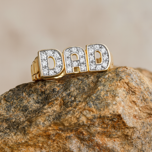 Mens 18ct Gold DAD Ring with Sparkling Letters on a Stone Background