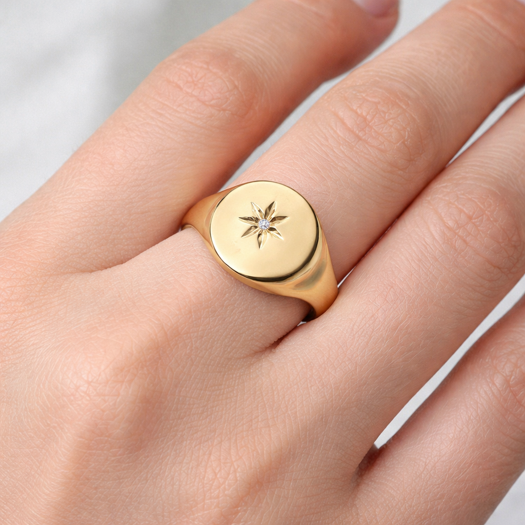 Mens 18ct Gold Oval Signet Ring featuring a star design, showcasing a polished finish