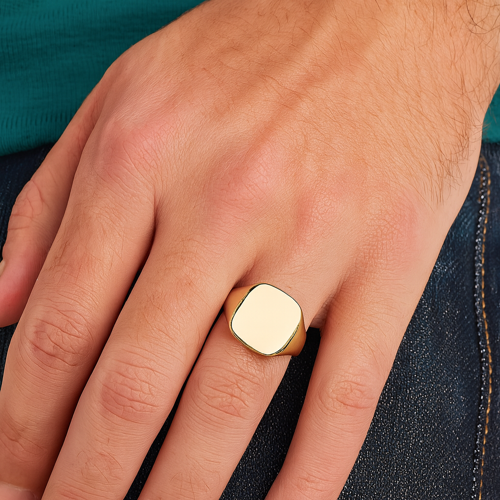 Mens 24ct Gold Cushion Signet Ring On Solid Sterling Silver worn on a hand with denim background