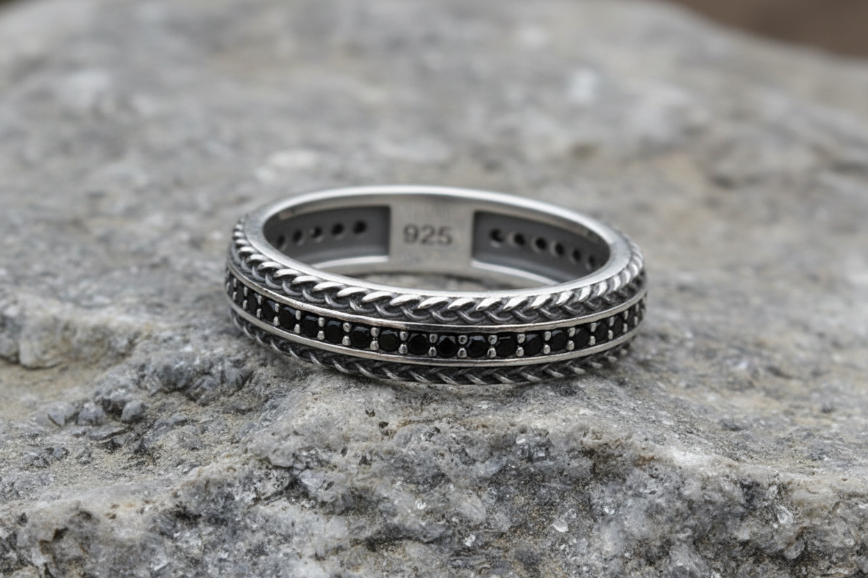 Mens Silver Band Ring Featuring a Black Cubic Zirconia Design on a textured surface
