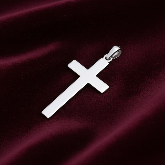 Plain Cross Pendant in polished silver resting on a burgundy velvet background