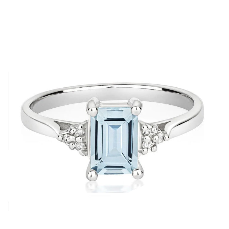 Elegant real aquamarine and diamond ring with a stunning emerald cut stone and sparkling accents
