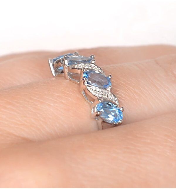 Real Blue Topaz And Diamond Eternity Ring showcased on a finger with elegant design and sparkling gemstones