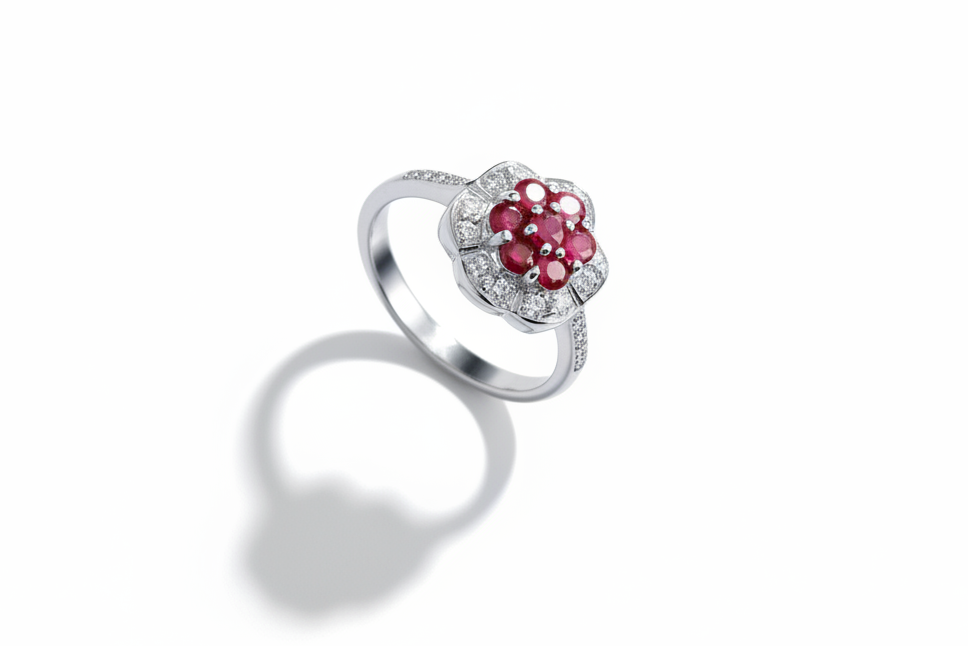 A ruby and diamond ring with a platinum finish on a white background.