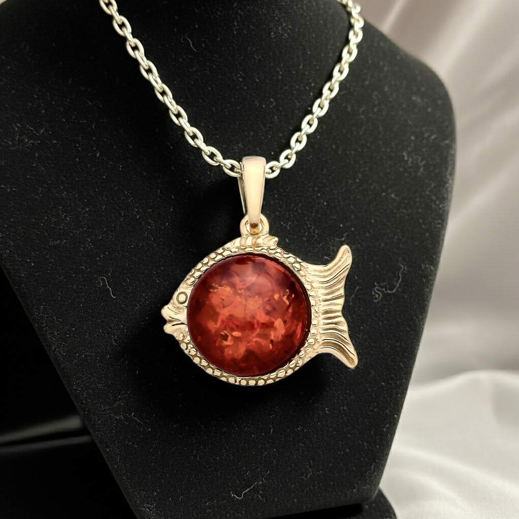 Silver necklace with a fish pendant featuring a red stone, perfect to pair with silver earrings sterling
