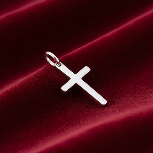 Elegant Silver Plain Cross Pendant displayed on luxurious burgundy fabric