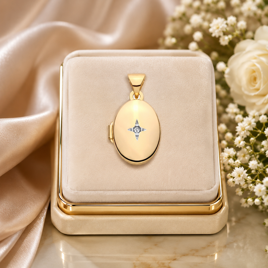 Small Gold Oval Locket displayed elegantly on a soft box with delicate flowers in the background