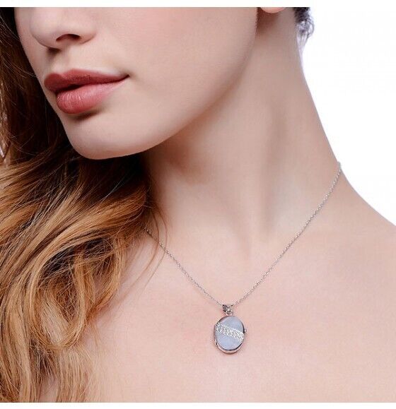 Elegant solid sterling silver oval locket worn on a delicate chain, perfect for personal keepsakes